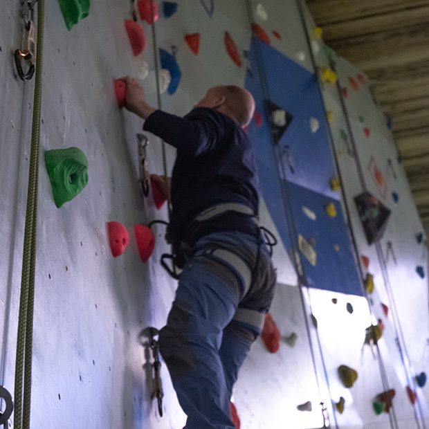 Picture of man climbing in climbing wall